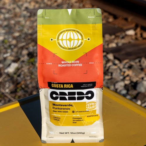 Coffee bag on a yellow surface with train tracks in the background