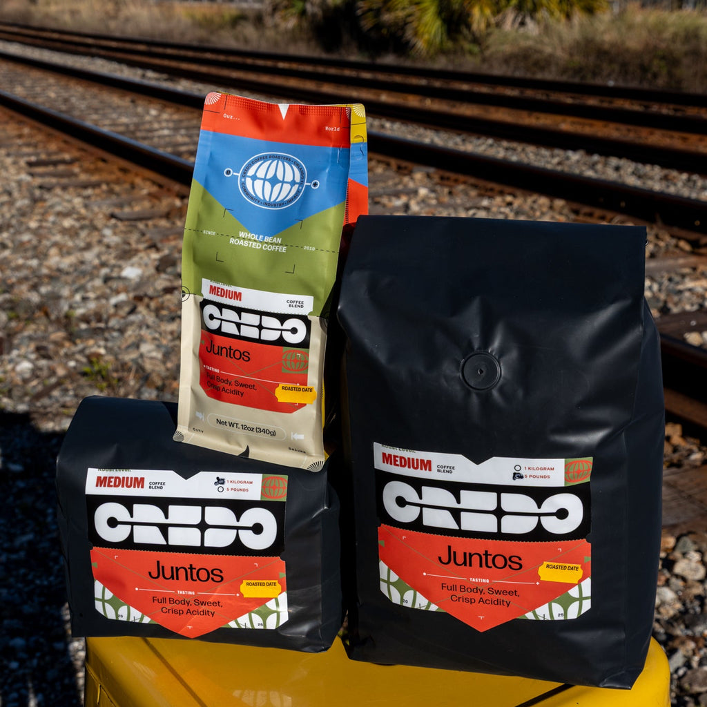 CREDO coffee bags on a yellow stool with train tracks in the background