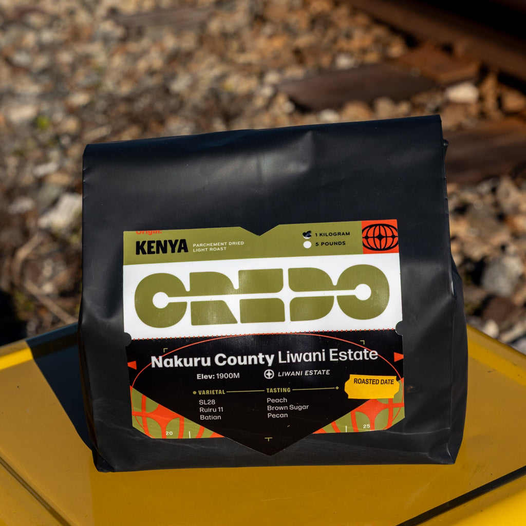 CREDO coffee package on a yellow surface with railway tracks in the background