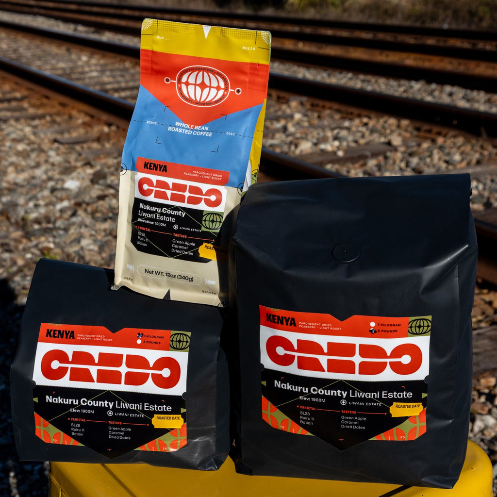 Credo coffee bags on a yellow stool with train tracks in the background