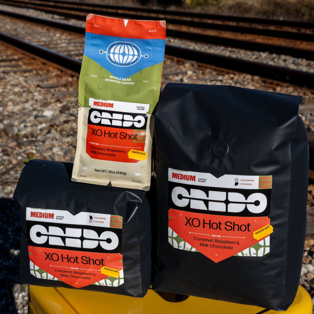 CREDO XO Hot Shot packages on a yellow stool with train tracks in the background